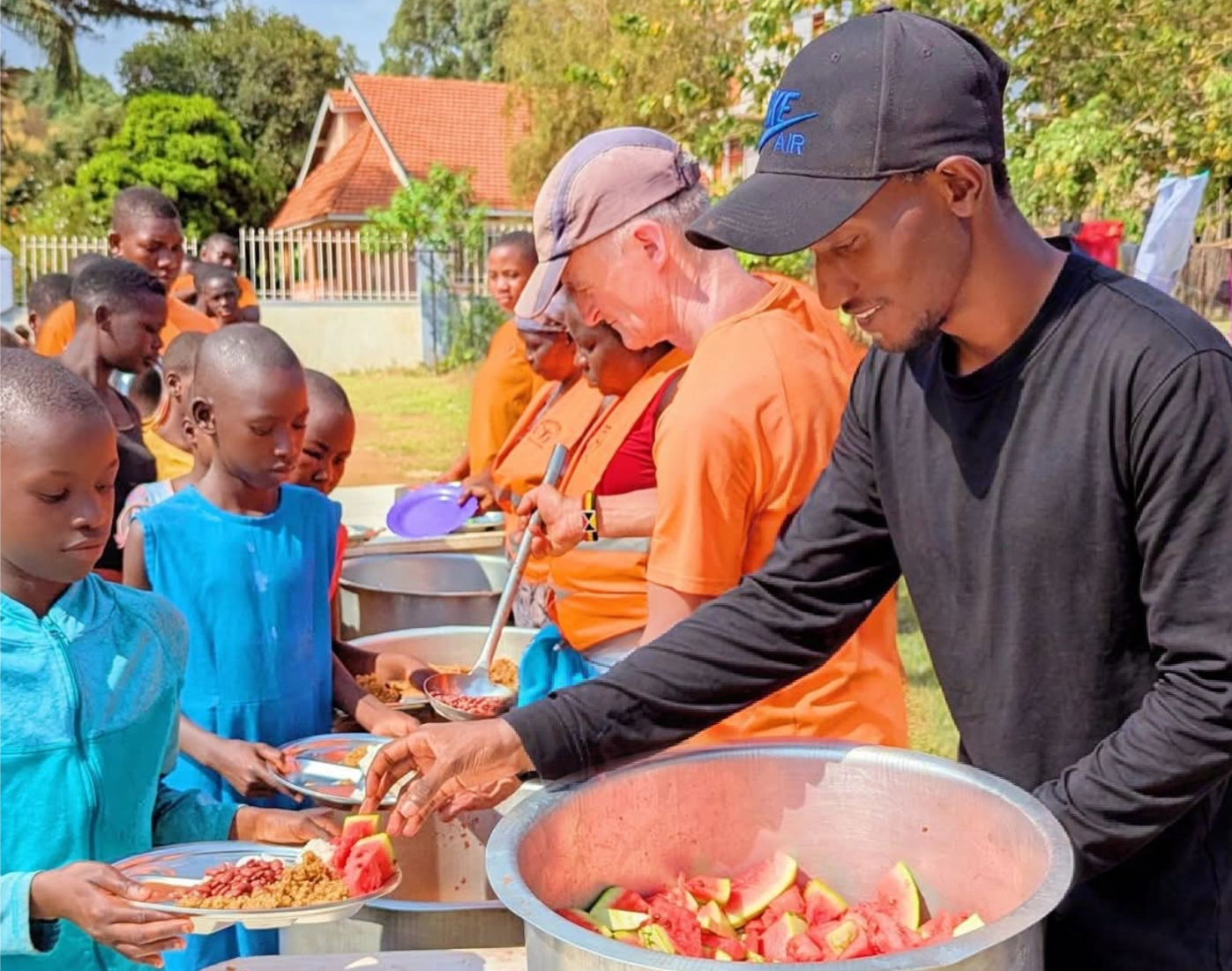 Volunteers and local staff serving meals